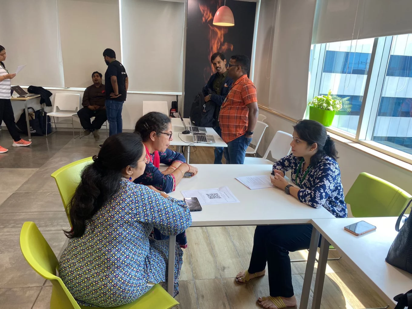 Megha discussing a personalised nutrition plan with two clients during a consultation