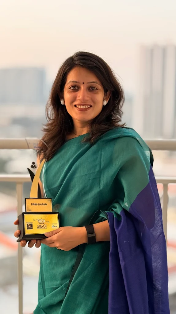 Megha holding an award